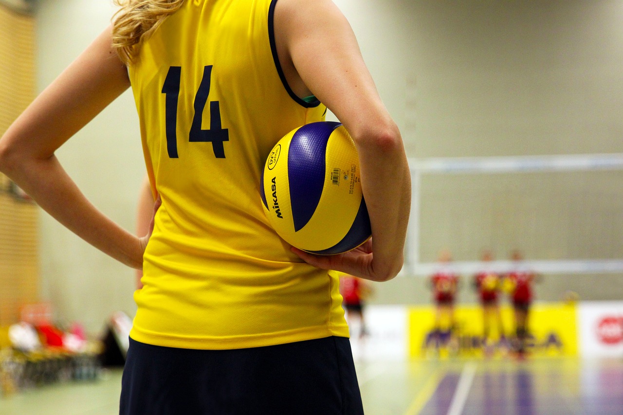 Teen athlete holding a ball at a sports game